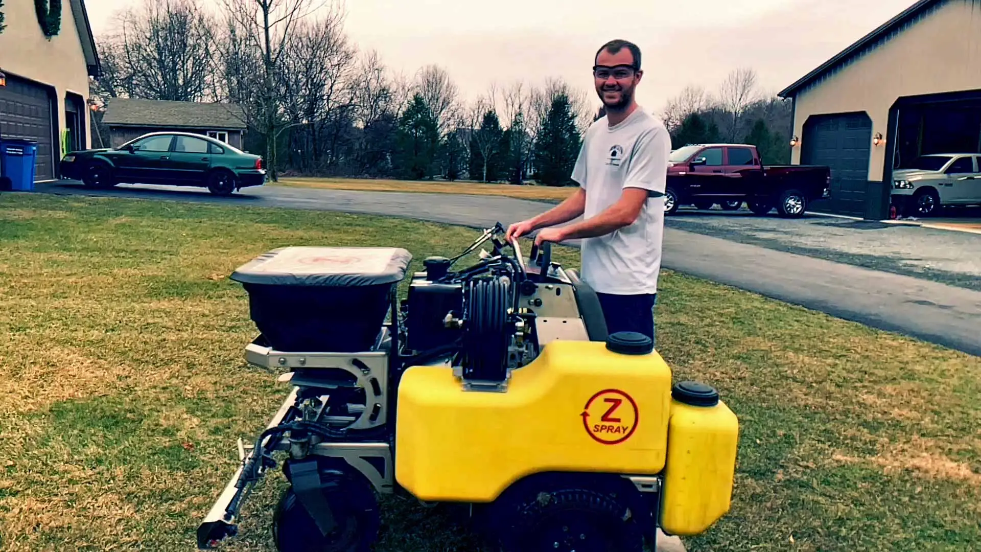 Fresh Cuts Lawn & Maintenance owner Austin Oldt using fertilization equipment in Allentown, PA.